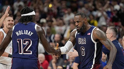 FRANCE. LeBron James (right), of the United States, celebrates with Jrue Holiday, of the United States, after scoring in a men's basketball game against Serbia at the 2024 Summer Olympics, Sunday, July 28, 2024, in Villeneuve-d'Ascq, France.