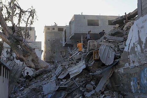 Palestinians search for bodies and survivors in the rubble of a residential building destroyed in an Israeli airstrike in Khan Younis, Gaza Strip, Wednesday, July 3, 2024.