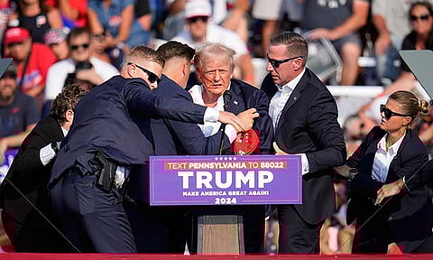 Republican presidential candidate former President Donald Trump is helped off the stage at a campaign event in Butler, Pa., on Saturday, July 13, 2024.