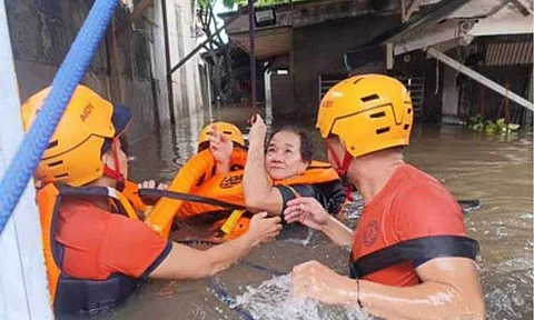 RESCUED. Philippine Coast Guard (PCG) members save a woman from floods in Zamboanga City on July 14, 2024. The NDRRMC reported Thursday (July 18, 2024) that the death toll from the effects of bad weather in Mindanao has climbed to seven. (Photo courtesy of PCG)