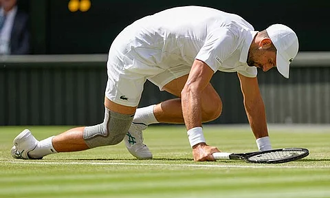 Serbia's Novak Djokovic falls during his second round match against Britain's Jacob Fearnley at the Wimbledon tennis championships in London, Thursday, July 4, 2024.