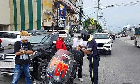 OBSTRUCTION TICKET. An enforcer from the CPOSCO Traffic Management Group issues a ticket to a motorist for obstruction during the start of road clearing operations on Monday. (Photo courtesy of CSFP CIO)