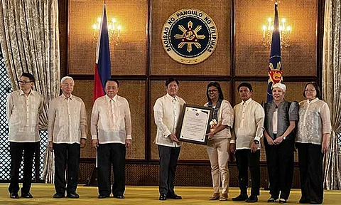 President Ferdinand “Bongbong” Marcos Jr., fourth from left, hands the Presidential Recognition for Outstanding Development Partner to Lamac Multipurpose Cooperative, represented by the coop’s general manager Ma. Elena Limocon, fourth from right, during the 2024 Presidential Awards for Outstanding Micro, Small, and Medium Enterprises on July 10, 2024.