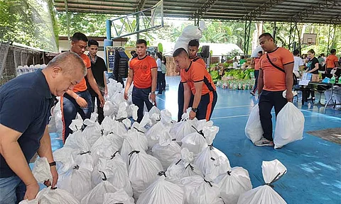 FOOD PACKS FOR FISHERFOLKS. Personnel of the Philippine Coast Guard Civil Relations Service prepare food packs donated by Tanging Yaman Foundation at Ateneo de Manila University on August 2 for distribution to oil-spill hit communities and local fisherfolks in Bataan and Cavite. (Photo courtesy of Philippine Coast Guard)