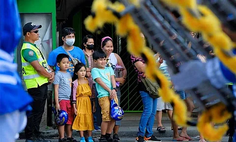 'DISCIPLINED FAMILY.' The "Pamilyang Dabawenyo, Disiplinado" bagged this year's first-place award for the Hulagway sa Araw ng Dabaw 2024. The photo by Excelsio Hiponia Jr. depicted a family that stayed within the designated area and was excitedly watching the parade during the Parada Dabawenyo Event. It also shows the marshal’s efforts in keeping the area organized for the convenience of the families and other spectators and for them to fully enjoy the parade.