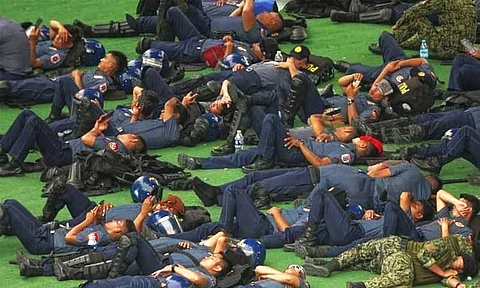 DAVAO. Some of the police officers deployed at the Kingdom of Jesus Christ (KOJC) Compound are spotted taking turns to rest.