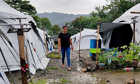 Nelly Ann Darling Salise, one of the survivors of the tragic Masara landslide, is seen walking along the tents located at their temporary shelter within the Quasai Parish in Barangay Elizalde, Maco. Salise shared to SunStar Davao that aside from the 2024 landslide, she also survived a landslide in 2008, still in Masara, carrying her then-three month old baby.