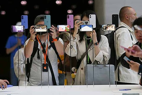Attendees take a closer look at the Apple iPhone 16 during an announcement of new products at Apple headquarters Monday, Sept. 9, 2024, in Cupertino, California.