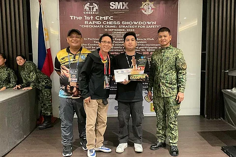 INAUGURAL CHAMPION. Davao Cityās Fide master (FM) Austin Jacob (AJ) Literatus receives his championās trophy and cash prize after topping the 1st NCA Open title at the SMX Convention Center, SM Lanang, over the weekend.