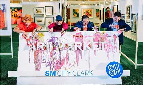 Paint splashed on the marker during the opening ceremony of the Art Market at SM City Clark