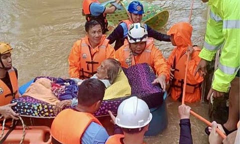 RESCUE. Search and rescue teams help evacuate a senior citizen in Batac City, Ilocos Norte province on Monday (Sept. 30, 2024) amid the onslaught of Typhoon Julian. House Speaker Martin Romualdez said the government is working to expedite the release of over PHP100 million in cash aid for affected families. (Photo courtesy of Batac CDRRMO)