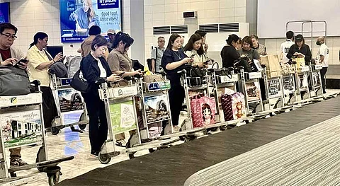 MANILA. Photo showing Teresita Sy-Coson, vice chairperson of the SM Group and one of Asia’s wealthiest women, standing patiently at the airport’s baggage claim.