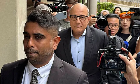 Former Transport Minister S. Iswaran, center, and his lawyer Navin Thevar arrive at the High Court in Singapore, July 5, 2024.