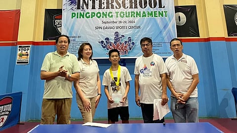 PINGPONG PRINCE. Zachary Apolonio of Jose Maria College (JMC)-Davao City, center, proudly receives his medal and prize from the organizers after winning the secondary boys division title at the recently concluded First Mindanao Interschool Pingpong Tournament held at Spin Davao Sports Center.