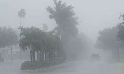 A Lee County Sheriff's officer patrols the streets of Cape Coral, Fla., as heavy rain falls ahead of Hurricane Milton, Wednesday, Oct. 9, 2024.