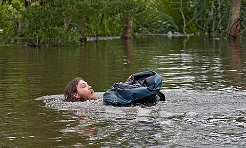 Connor Hughes of Lithia, Fla., moves in deep floodwaters from Hurricane Milton along the Alafia river Friday, Oct. 11, 2024, in Lithia, Florida.
