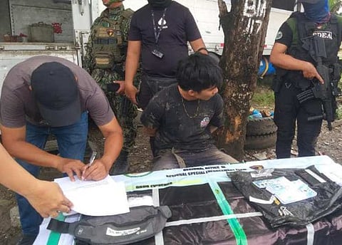 ZAMBOANGA. Authorities arrest a mechanic and seize some P680,000 worth of illegal drugs in an anti-drug operation at Zone 2, Boalan village, Zamboanga City on Tuesday, October 22. A photo handout shows Philippine Drug Enforcement Agency personnel conducting inventory on the pieces of evidence seized from the suspect (seated, right).