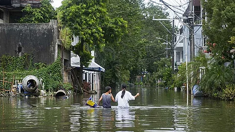 RIZAL. Residents walk along the flooded village caused by Tropical Storm Kristine (Trami) on Friday, October 25, 2024, in Cainta, Rizal province, Philippines.