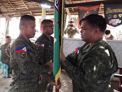 ZAMBOANGA. The Army’s 45th Infantry Battalion (45IB) initiates changes in the leadership of its Bravo Company. A photo handout shows Lieutenant Colonel Michael Colanta, 45IB commander (right), handing over the Bravo Company command flag to First Lieutenant Romel Aglibot (left), who replaced Captain Vinjoe Coña (Center), during the change of command ceremony at the company’s headquarters on Wednesday, October 25, in Tipo-Tipo proper village, Tipo-Tipo, Basilan.