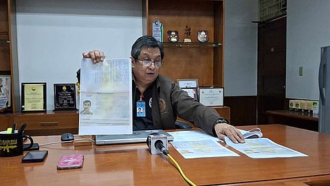 CEBU. National Bureau of Investigation Central Visayas head Renan Agustus Oliva shows a copy of the passport of one of the three Indonesians.