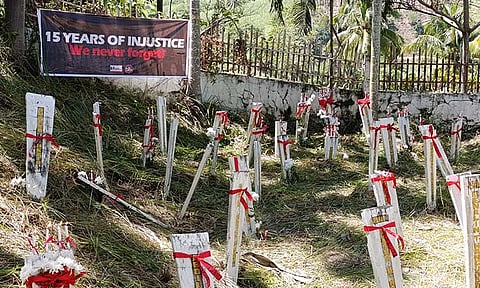 The markers tied with ribbons bearing the message Justice Now at the massacre site in Maguindanao del Norte.