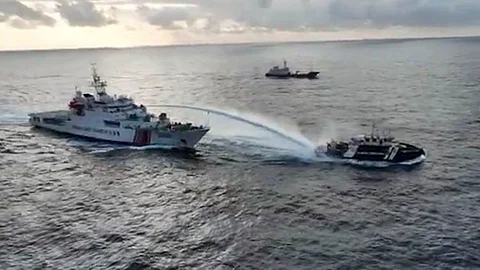 MANILA. In this image made from a video provided by the National Task Force for the West Philippine Sea (NTF-WPS), a Chinese coast guard vessel (left) fires a powerful water cannon on a Philippine bureau of fisheries vessel near a disputed shoal in the South China Sea Wednesday, December 4, 2024.