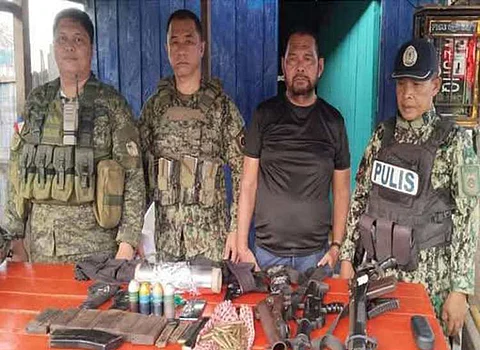 ZAMBOANGA. Military and police forces seize firearms without resistance from a group of persons creating tensions in a law enforcement operation in a community in Pandami, Sulu, on Saturday, January 25. A photo handout shows military and police officials posing with the confiscated unlicensed guns placed on the table in front of them.