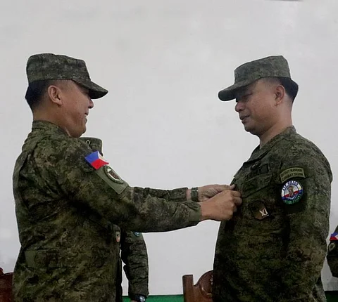 ZAMBOANGA. The Philippine Army promotes to the next higher rank four senior officers assigned to the 11th Infantry Division (11ID) based in Sulu. A photo handout shows Major General Leonardo Peña, 11ID commander (left), pinning the insignia of the new rank to one of the four promoted officers, Lieutenant Colonel Erwin Cariño (right), who was promoted to the rank of Colonel in a simple donning of rank ceremony on Thursday, January 23, at Camp Teodulfo Bautista that houses the 11ID headquarters in Busbus village, Jolo, Sulu.