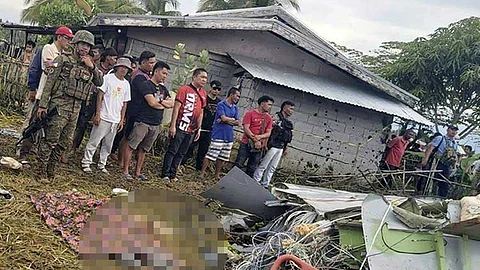 MAGUINDANAO. The body of a victim is covered with a blanket as members of security forces stand around wreckage of airplane in a rice field in Maguindanao del Sur province, Philippines, after officials say a US military-contracted plane has crashed in a rice field in the southern Philippines, killing all four people on board, on Thursday, February 6, 2025.