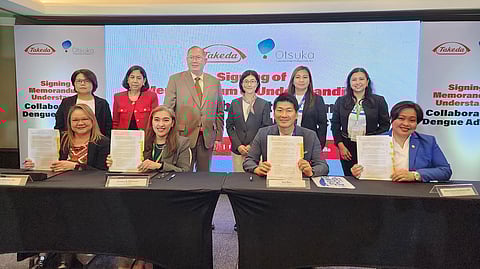Takeda Healthcare Philippines Inc. led by Country Manager Loreann Villanueva (seated, second from the left) and Otsuka-Solar Philippines, Inc. led by Company President Ken Saito (seated, second from the right), with the support of the Embassy of Japan in the Philippines represented by Health Attaché Dr. Fumiko Aoki (standing, third from the right) signed a Memorandum of Understanding to raise awareness on dengue and advocate for an integrated approach to prevention and control of the disease. Former Department of Health Undersecretary Dr. Eric Tayag (standing, fourth from the right) together with both firms' executives joined to witness the beginning of the Japanese companies' alliance.