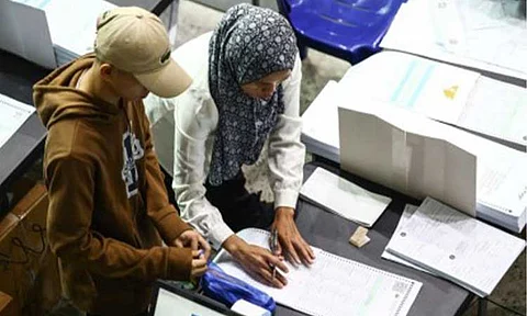DOUBLE-CHECK. Verifiers of the Commission on Elections inspect printed ballots for the May 12 national and local elections, at the Amoranto Sports Complex in Quezon City on Thursday (Feb. 13, 2025). Comelec had already printed some 27 million official ballots since the reprinting process late January, representing 37 percent of a total 72,107,420.