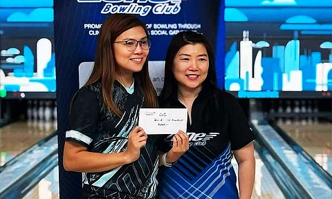 FROM PH TO CANADA. Davao City bowler Tessa Dianne Galendez-Lim, left, receives her cash prize in her first competition in Canada.