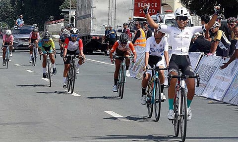 Jazmin Kaye Vinoya raises her hands to signal her victory in the Women Junior road race on Wednesday.