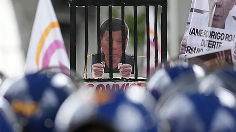 MANILA. An illustration of former President Rodrigo Duterte behind bars is held by activists as policemen blocked their march toward Malacañan Palace in Manila, Philippines on Monday, March 17, 2025, during a rally calling on the government to rejoin the International Criminal Court (ICC) following the recent arrest of Duterte.