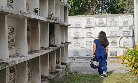 A cemeterygoer visits the Wireless Cemetery along Fr. Selga Street in Davao City on October 29, 2025, days before All Saints' Day and All Souls' Day.
