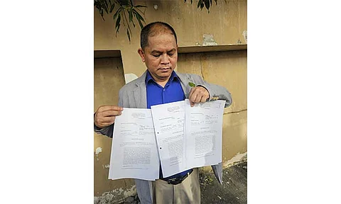 Comelec Region 3 Assistant Regional Director Elmo Duque holds the information sheets about vote-buying cases filed against San Fernando mayor Vilma Caluag, her husband Melchor Caluag, and Julmar Mercado. The cases stemmed from the complaint of one Alvin Garcia during the 2023 Barangay and SK elections. Photo by Ian Ocampo Flora