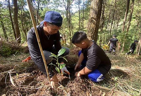 Resource conservation. A Hedcor team member and his son participate in a tree-planting activity in La Trinidad Hydro in Alapang, Benguet, which harnesses the Balili River.