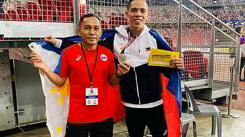 SILVER FINISH. Former Davao City standout Sonny Wagdos (right) shares a proud moment with national track and field coach Eduardo Buenavista after securing silver in the men’s 5,000-meter event at the 2025 Singapore Open Track and Field Championships on Thursday, April 24, at the National Stadium in Singapore.
