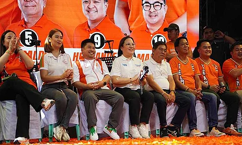 Fourth from left: Trabaho Partylist first nominee Atty. Johanne Bautista, seated between Mayor Along Malapitan and Cong. Oca Malapitan, is all smiles during the Team Aksyon and Malasakit’s Grand Rally at Distrito Uno, Caloocan City.