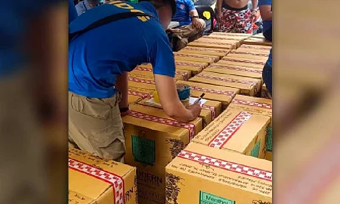 ILLICIT TRADE. A Criminal Investigation and Detection Group (CIDG) agent inspects boxes of counterfeit cigarettes confiscated in a four-day operation from May 1 to 4, 2025. Under the “Oplan Mega Shopper,” the CIDG seized PHP41.8 million worth of smuggled cigarettes. (CIDG photo)