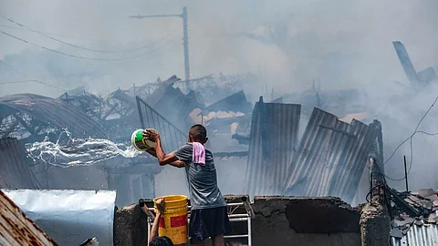 A fire engulfed several houses in a residential area of Basak, Lapu-Lapu City, on Friday morning, May 30, 2025. Authorities are still investigating the cause of the blaze. | via Juan Carlo de Vela