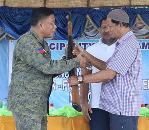 ZAMBOANGA. The 1102nd Infantry Brigade (1102Bde) launches the Gun-Free and Peace-Centered Community Campaign on Sunday, June 8, in Panamao, Sulu. A photo handout shows Colonel Alex Gagula, 1102Bde deputy commander (left), received a rifle, one of three that were surrendered during the launched of the campaign.