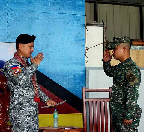 ZAMBOANGA. A Marine Battalion Landing Team-1 personnel, who completed the Squad Designated Marksmanship Training, proudly salutes Captain Larry Cendaña, Zamboanga Coast Guard Station commander (left), the guest of honor and speaker, during the graduation ceremony on Tuesday, June 10, at Naval Station Rio Hondo in Zamboanga City.