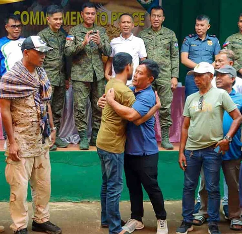 ZAMBOANGA. Former Tuburan Mayor Durie Kallahal (in blue shirt) and Abdulla Jhovel, leaders of two feuding clans, embrace each other as they peacefully settle their nearly decade-old disputes through the intercession of the 101st Infantry Brigade. The reconciliation ceremony was held Sunday, June 15, at the 18th Infantry Battalion (18IB) headquarters in Campo Uno village, Lamitan City, Basilan province.