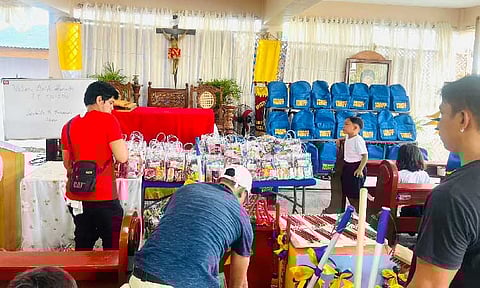 BLESSINGS TO STUDENTS
Students of San Nicolas Elementary School in Masantol town receive assistance from private groups on the first day of classes. With several classrooms flooded due to rain and high tide level, classes are temporarily being held at the nearby San Nicolas Chapel. - Photo by John Kristoffer Yabut