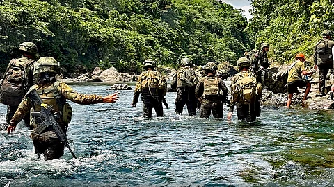 Soldiers from the 82nd Infantry Battalion and partner agencies trek through rivers and rough terrain to reach Barangay Dalagsa-an in Libacao, Aklan, bringing vital government services to residents as part of a three-day Serbisyo Caravan held from June 15 to 17, 2025. (Photo courtesy of the 82IB)