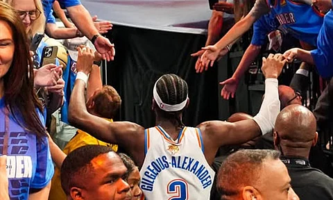 THUNDER STAR. Oklahoma City Thunder guard Shai Gilgeous-Alexander gives high-fives to a throng of enthusiastic fans while heading towards the exit after their Game 5 victory over the Indiana Pacers in the NBA Finals. /