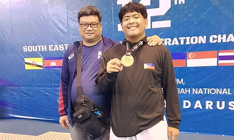 BRONZE MOMENT. Christopher Cagandahan proudly poses with Association for the Advancement of Karatedo (AAK) Davao regional director Rommel Tan after clinching bronze in the U21 +84kg Kumite at the 12th Southeast Asian Karate Federation Championship in Brunei.