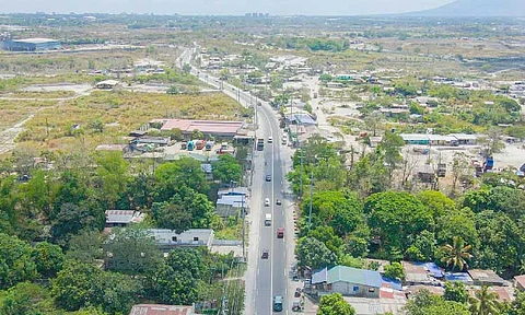 IMPROVED ROAD
An aerial view of the
Angeles-Porac-Floridablanca-Dinalupihan Road in Barangay Mancatian, Porac which underwent improvement recently. - DPWH photo