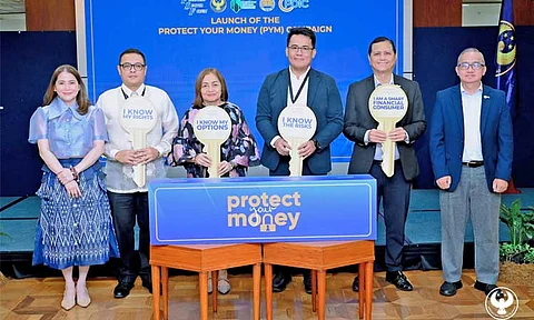 The Financial Sector Forum (FSF) launches the 2025 ‘Protect Your Money’ (PYM) information campaign to empower financial consumers and combat scams. Joining the launch on June 17, 2025 at the Bangko Sentral ng Pilipinas (BSP) head office in Manila are (from left) BSP Deputy Governor Bernadette Romulo-Puyat, Insurance Commission’s Juan Paolo Roxas, BSP Deputy Governor Chuchi Fonacier, Securities and Exchange Commission assistant director Paolo Cruz, Philippine Deposit Insurance Corp. president Roberto Tan and corporate affairs vice president Jose Villaret Jr.